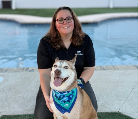 a woman sitting next to a dog