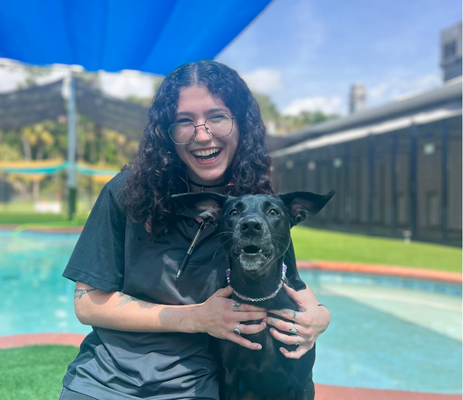 a woman holding a dog