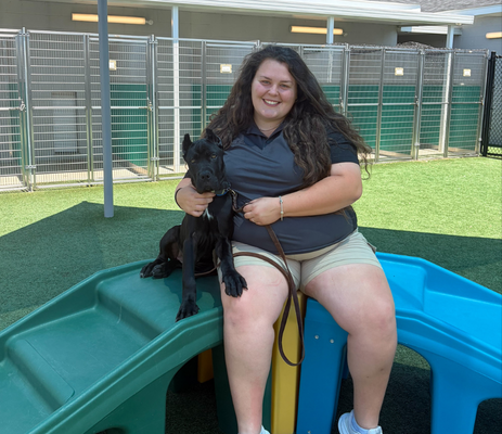 Dog Trainer sitting with puppy