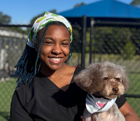 a woman holding a dog