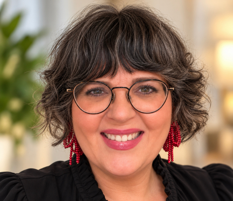a woman wearing glasses and smiling