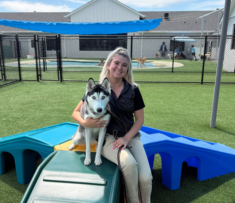 a woman sitting on a dog