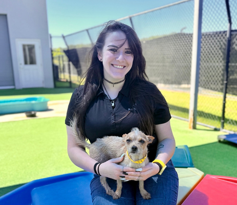 a woman holding a dog