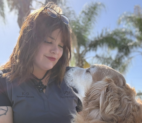 a woman with her eyes closed and a dog