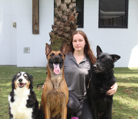 a woman with dogs posing for a picture
