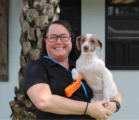 a woman holding a dog