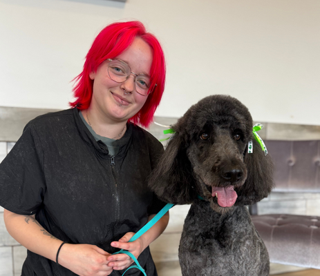 a woman with red hair and a dog