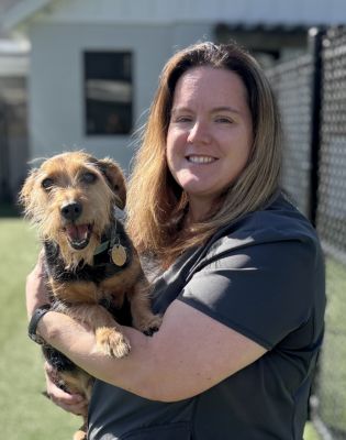 a woman holding a dog