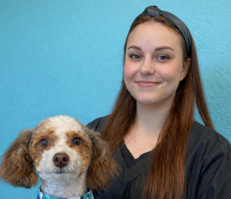 a woman smiling with a dog