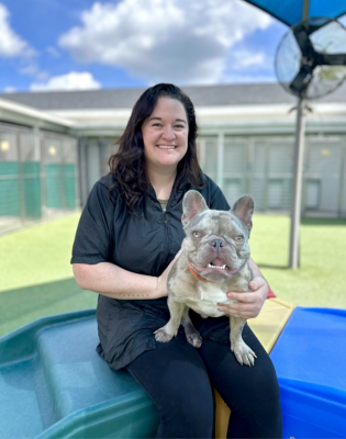 a woman holding a dog