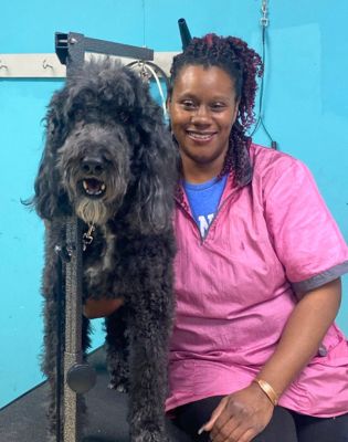 a woman sitting next to a dog