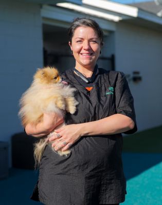 a woman holding a dog