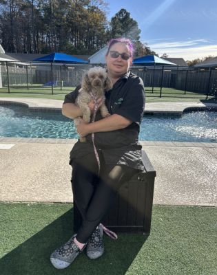 a woman holding a dog