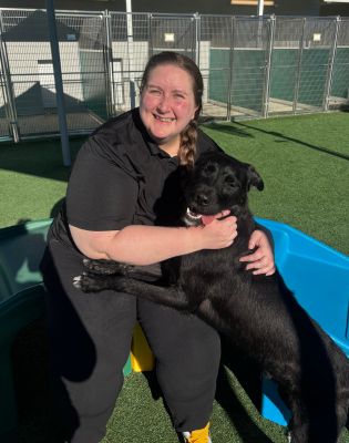 a woman holding a dog