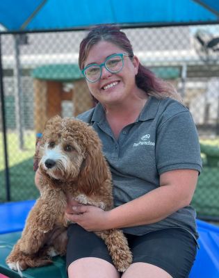 a woman holding a dog