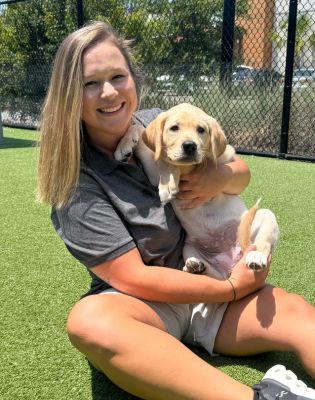 a woman holding a puppy