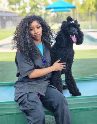 a woman sitting on a bench with a dog