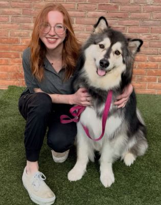 a woman sitting with a dog