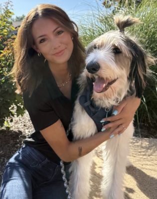 a woman holding a dog