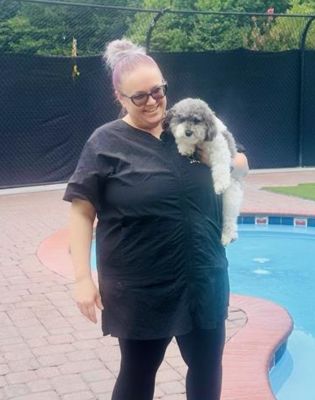 a woman holding a dog