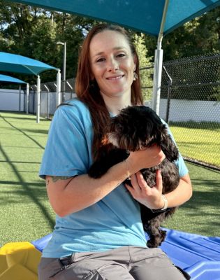 a woman holding a dog