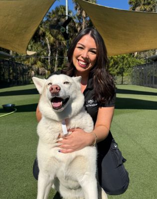 a woman holding a dog
