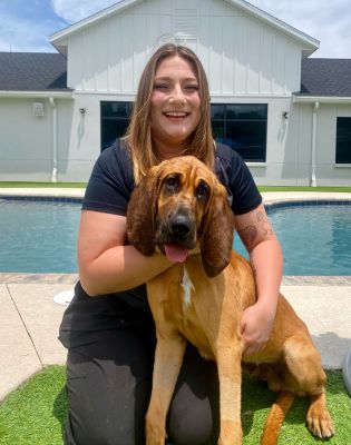 a woman holding a dog