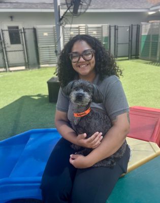 a woman holding a dog
