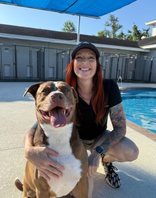 a woman with a dog by a pool