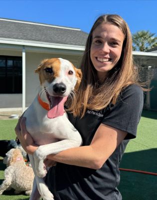 a woman holding a dog