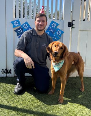 a man and a dog posing for a picture
